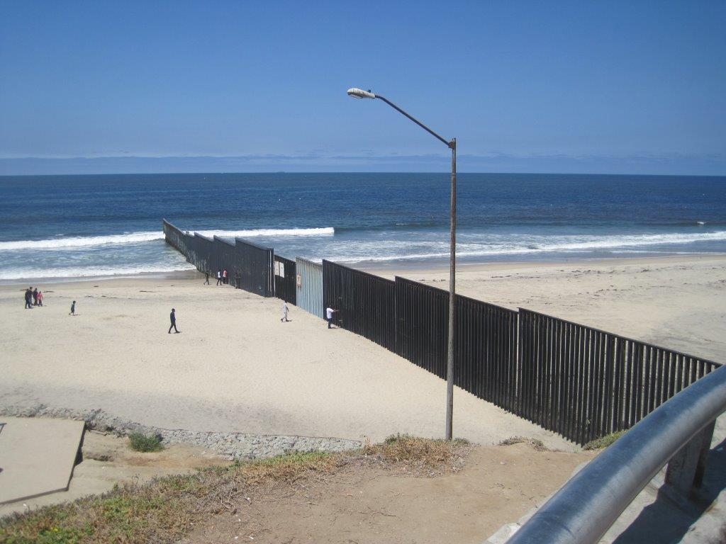 Border fence extending into the ocean